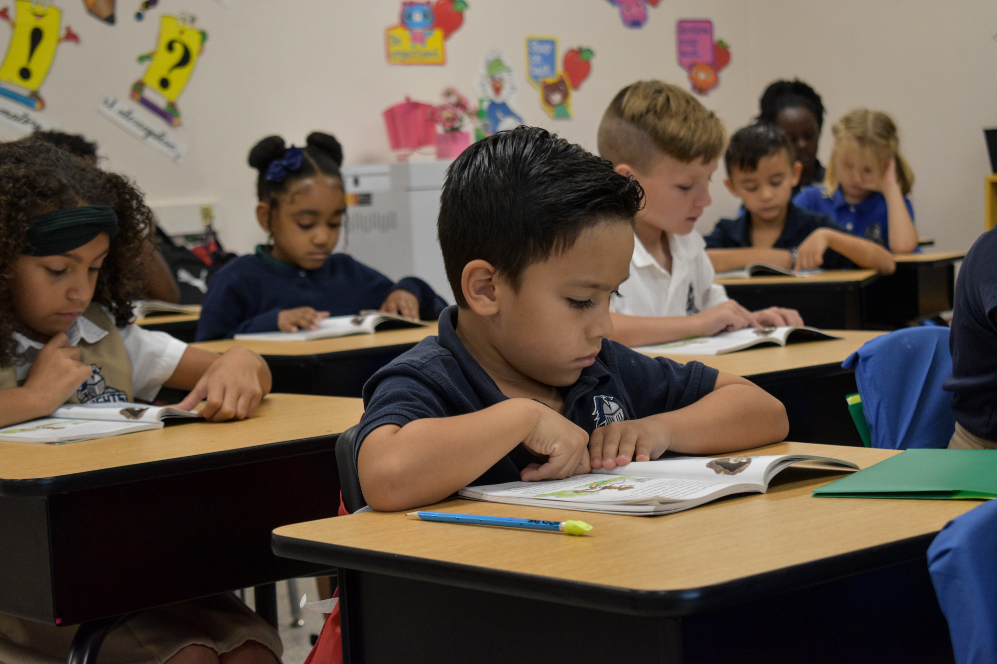 teacher helping student write