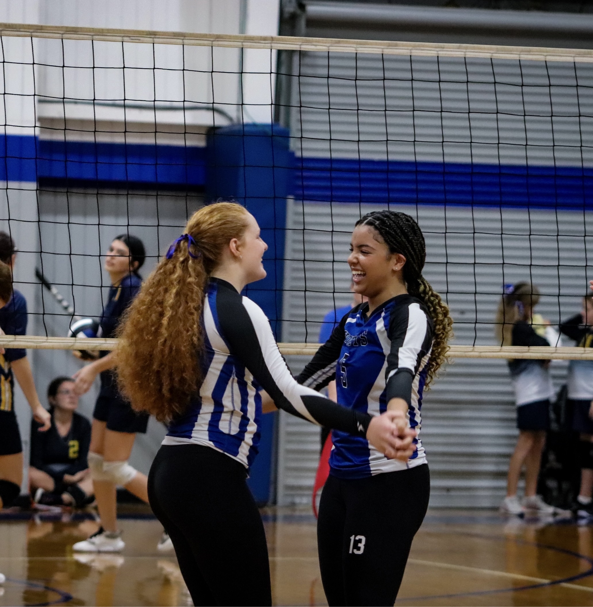 high school girl getting ready to serve volleyball